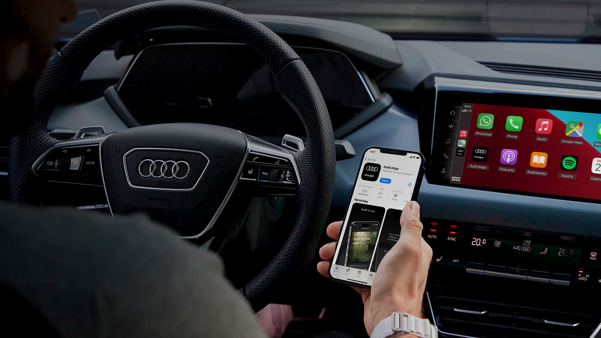 Person sits in the Audi and uses the Audi stage app on their cell phone